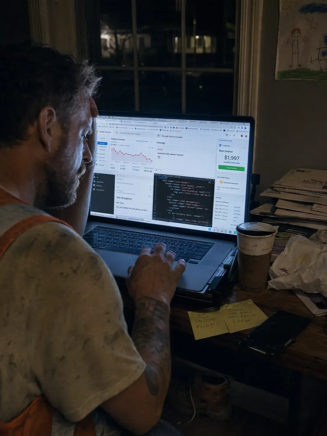 Contractor at a laptop late at night managing his own SEO dashboard