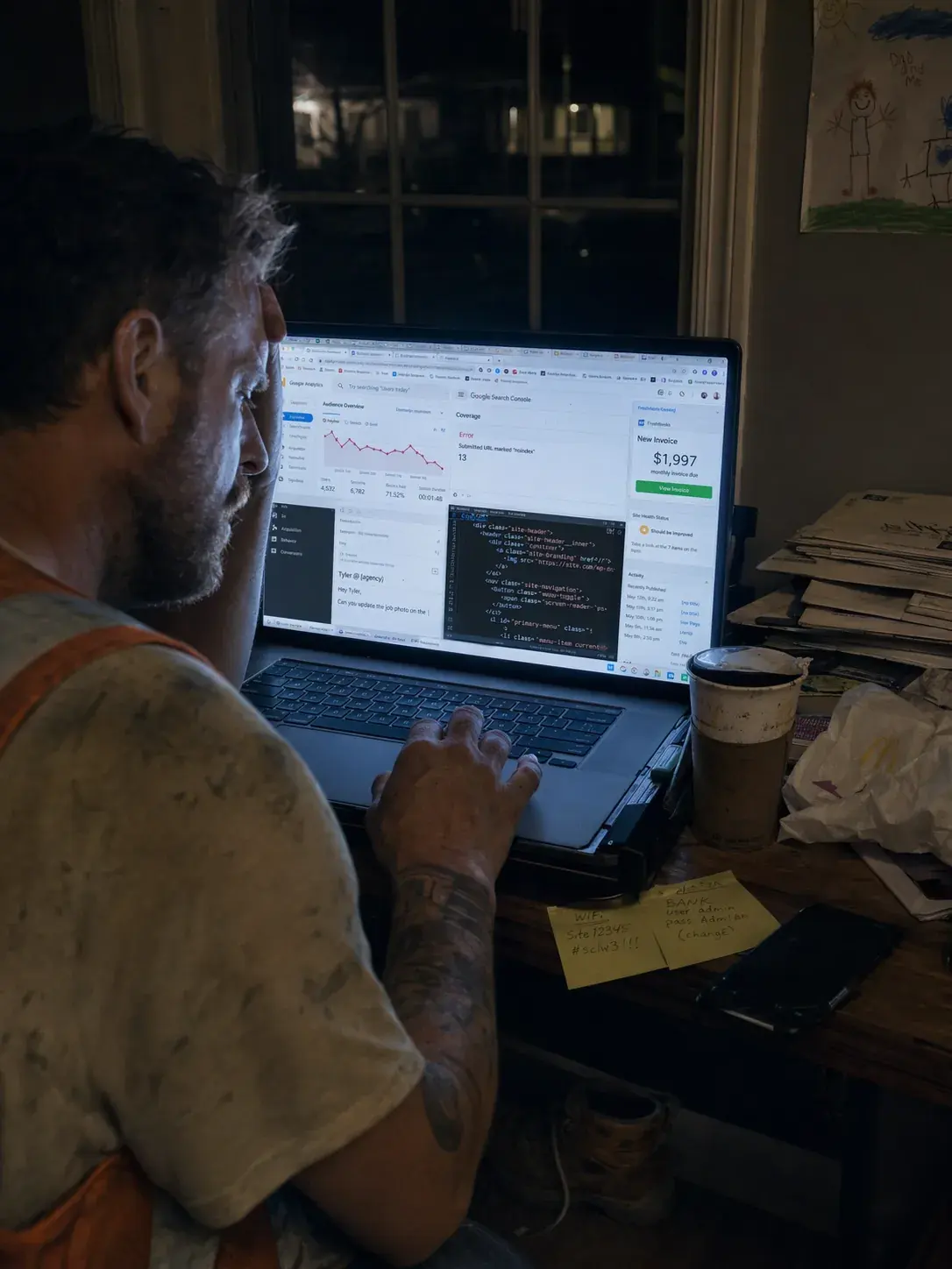 Contractor at a laptop late at night managing his own SEO dashboard